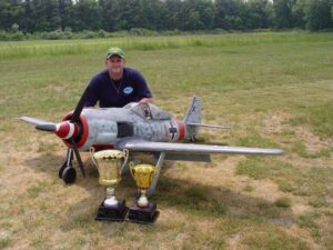 Owner proudly poses with Model Aircraft and trophies won